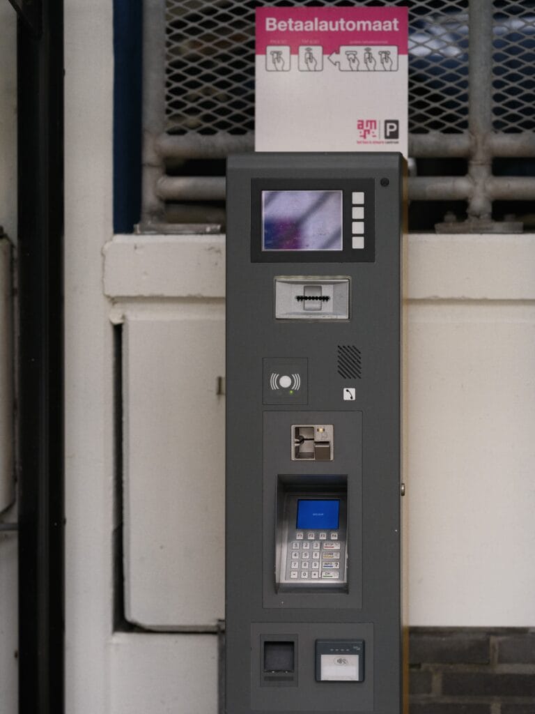 Close-up of a parking payment terminal in an indoor garage in Almere, Netherlands.