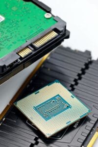 High-resolution close-up of a CPU processor, RAM sticks, and a hard drive, showcasing modern computer hardware.