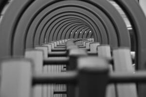 Monochrome image showcasing concentric circles in a tunnel-like structure creating a sense of depth.